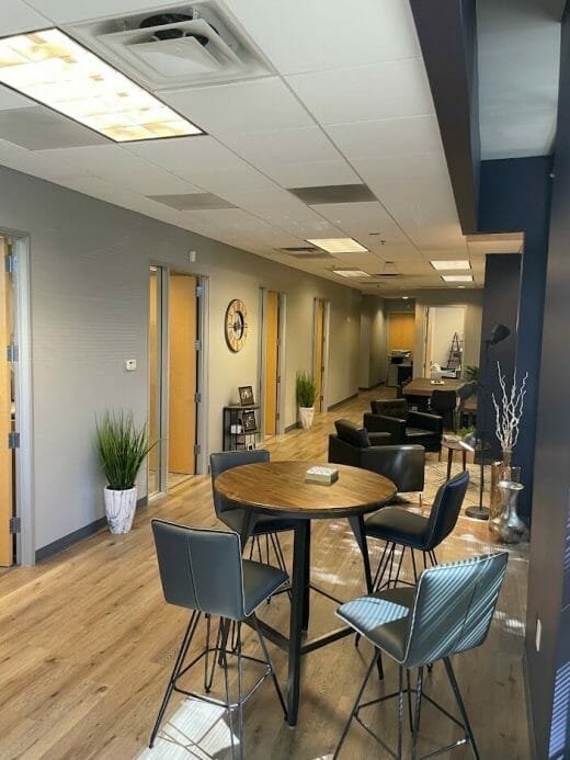 A room with a table and chairs in an office.